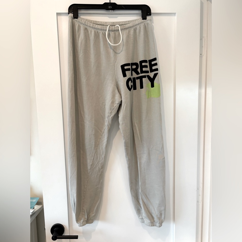 Free City sweatpants size Medium, light grey with black and neon yellow logo.